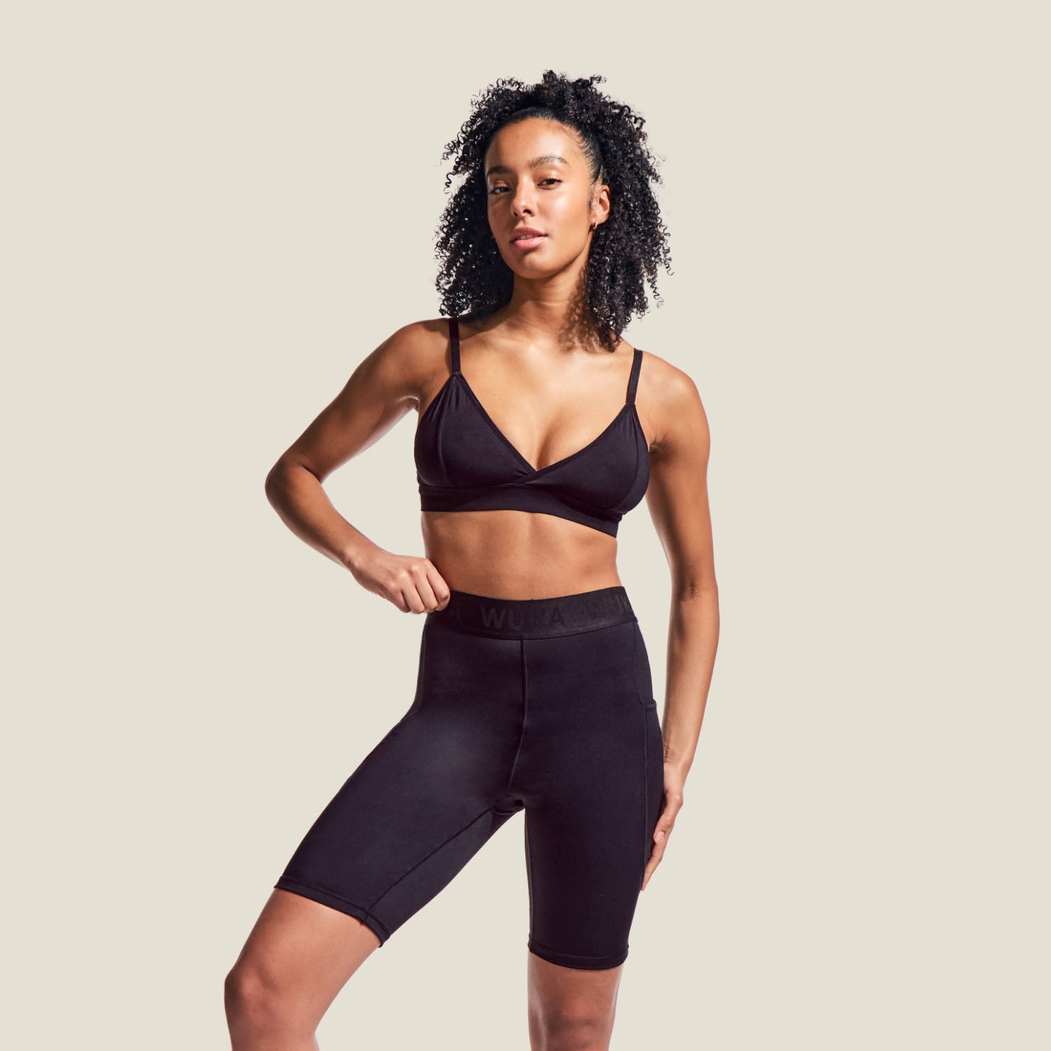 Model wearing WUKA Perform Period Cycling Shorts for medium flow, full-length view highlighting athletic fit and sustainable period protection.