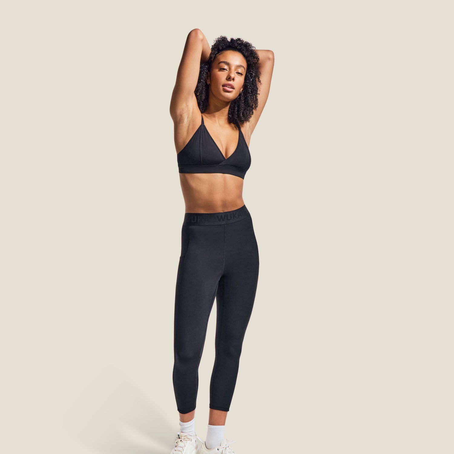 Model wearing WUKA Period Activewear Leggings for medium flow, full-length view showcasing high-waisted fit and athletic design.