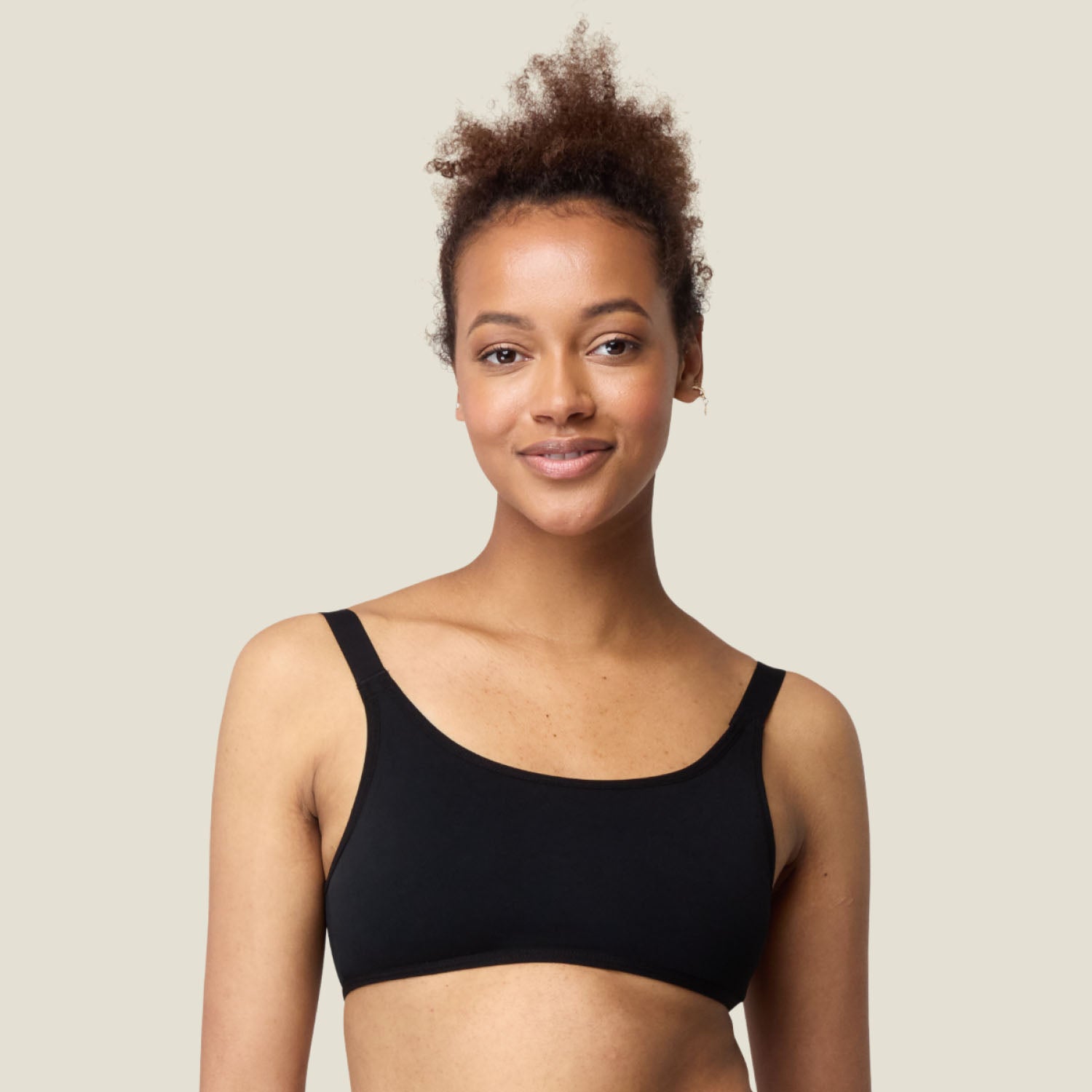 Teen wearing WUKA Adjustable Bikini Top in black — soft, secure fit for active swim days.
