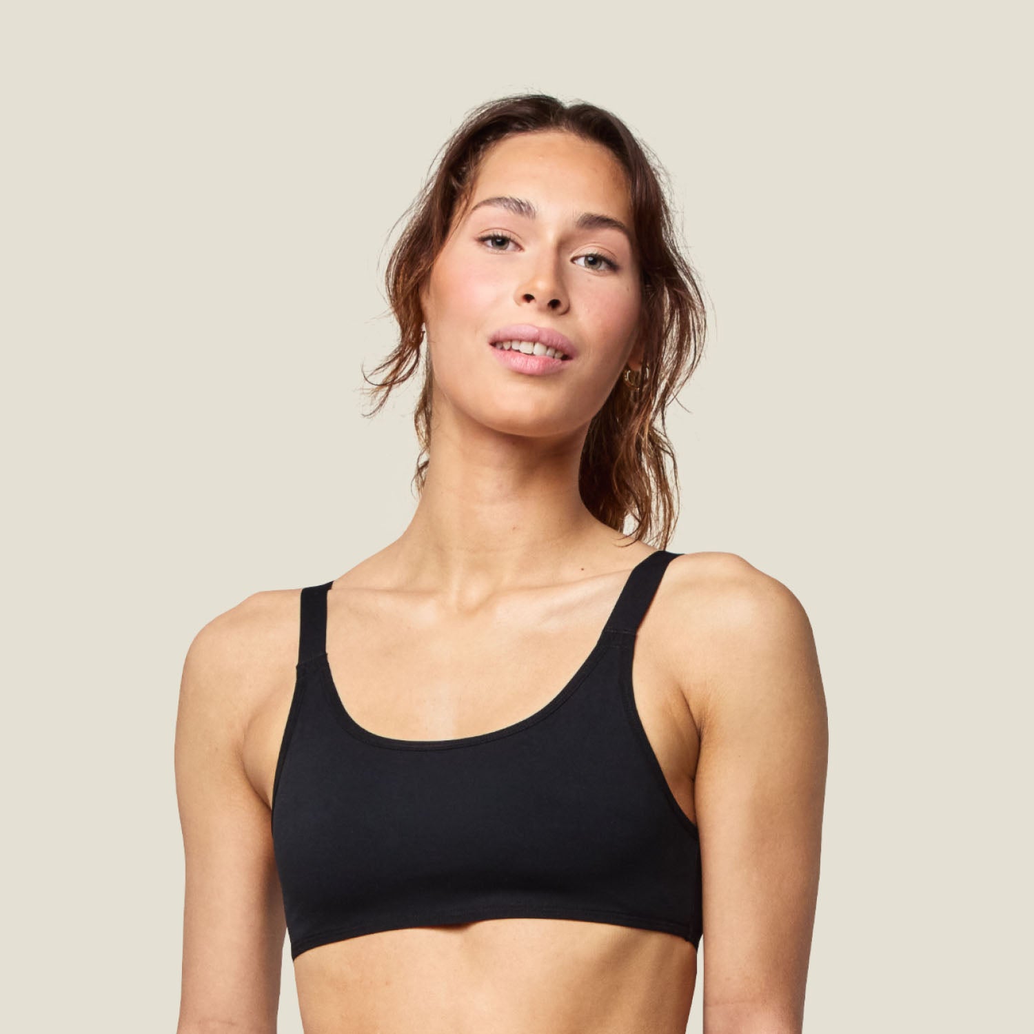 Teen Swim Bikini Top in Black shown from the front, featuring a classic scoop neckline and wide straps for secure, all-day support.