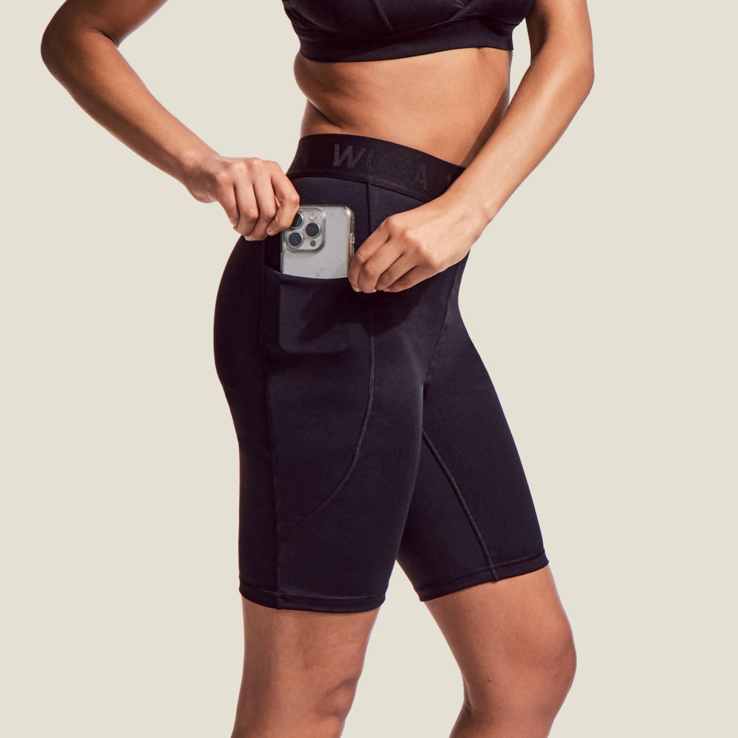 Close-up of WUKA Perform Period Cycling Shorts showing high-rise waistband and sleek design with phone pocket, ideal for workouts and everyday wear.