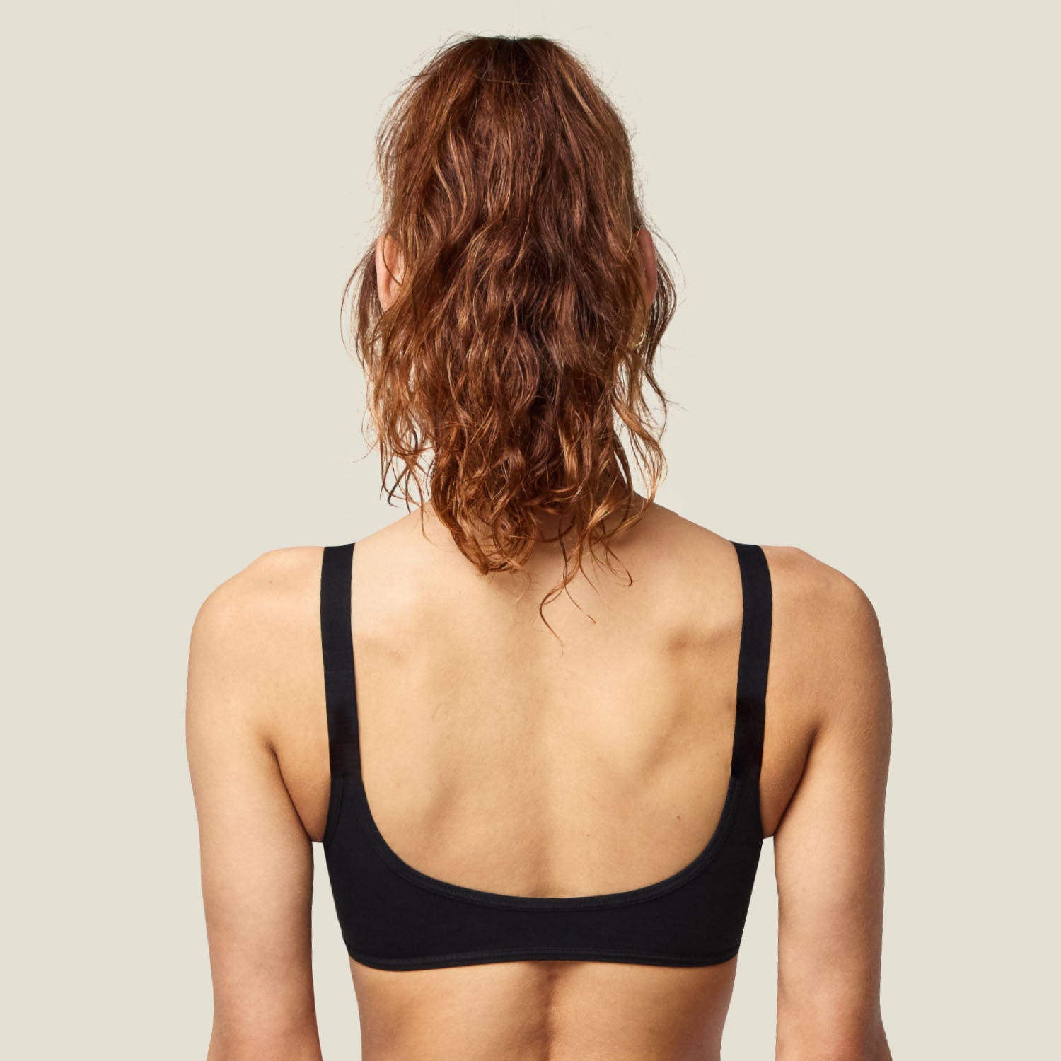 Back view of the Teen Swim Bikini Top in Black, showing a smooth, full-coverage fit with wide straps for added comfort.