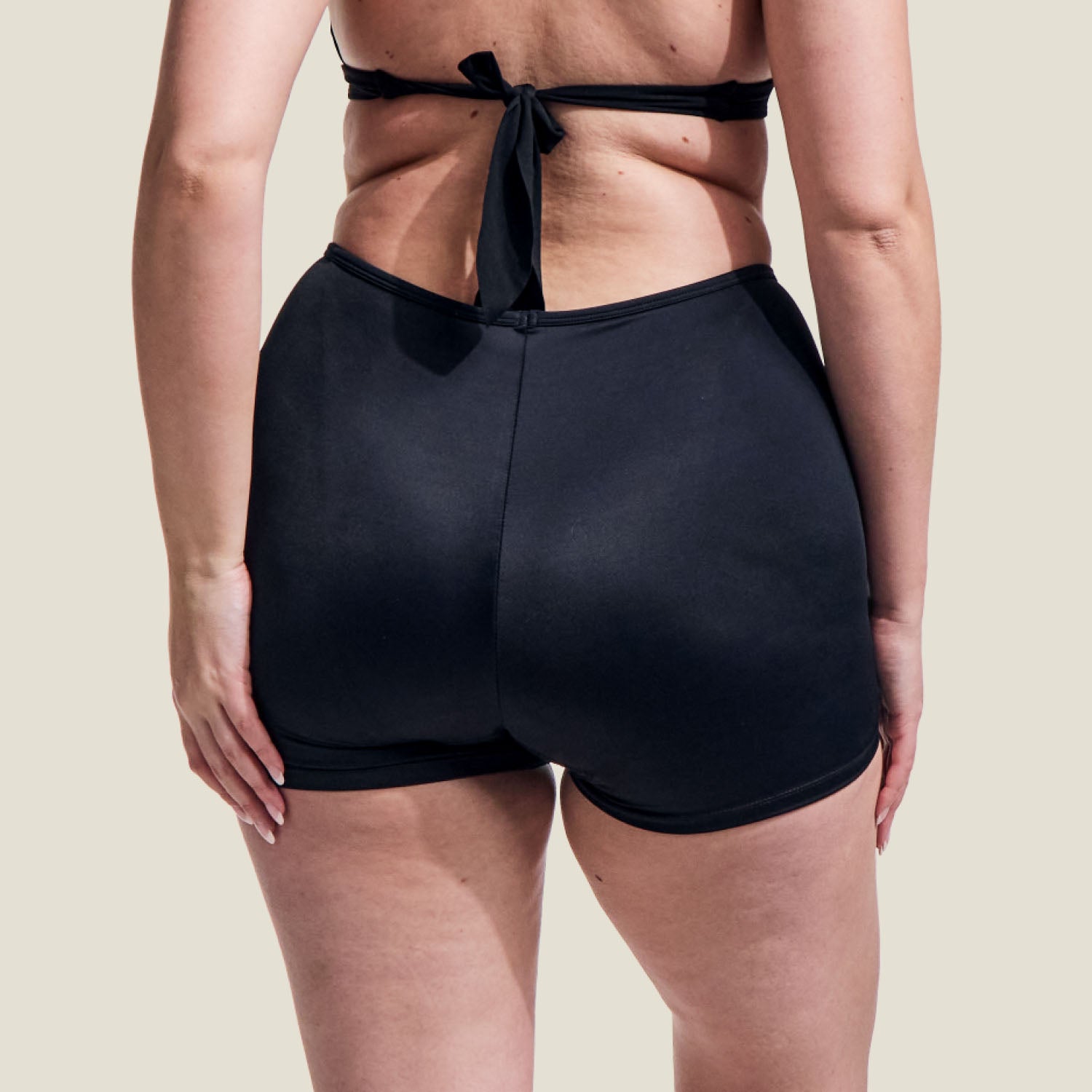 Back view of adult WUKA medium flow period swim shorts, highlighting full coverage and comfort-fit design.