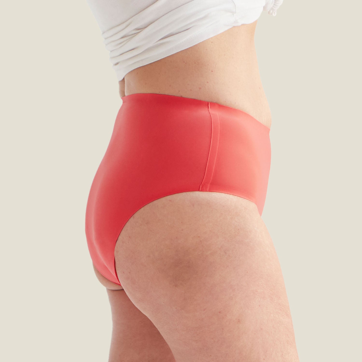 Side profile of the WUKA Drytech™ Midi Brief in Coral Pink showing its flattering high-rise cut and stretch-fit comfort.