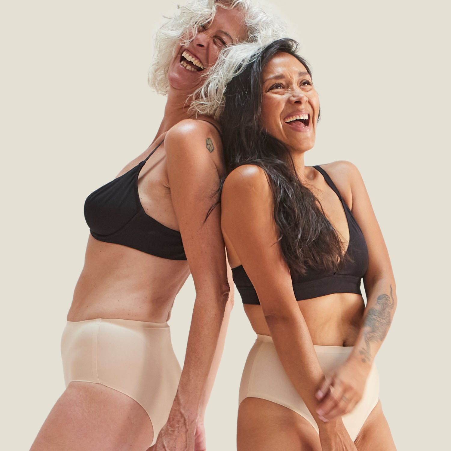 Two women wearing WUKA Drytech™ Incontinence Midi Briefs in Light Nude, showcasing inclusive fit and leak protection for light incontinence.