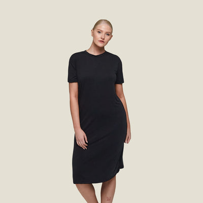 Model wearing WUKA Pyjama Jersey T-Shirt Dress in black, showcasing breathable, cooling sleepwear designed for menopause comfort.