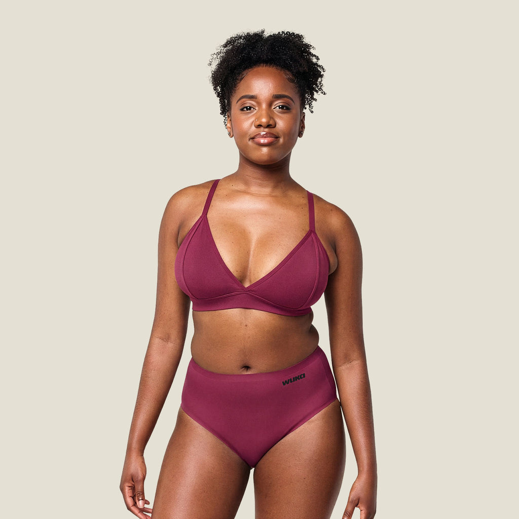 Model wearing WUKA Stretch Midi Brief in Burgundy for heavy flow – full body view showcasing comfort and fit